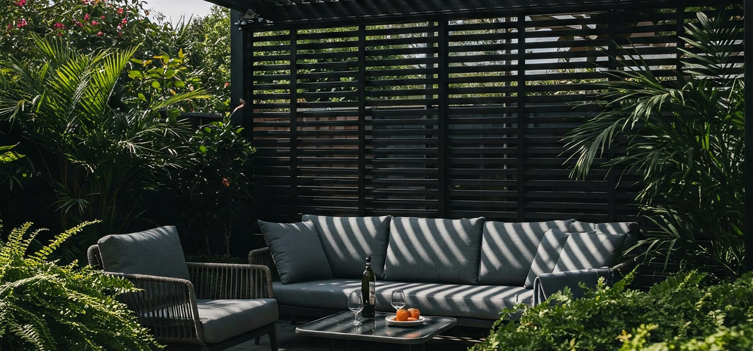 A modern pergola with slatted shade covering a patio with outdoor furniture.