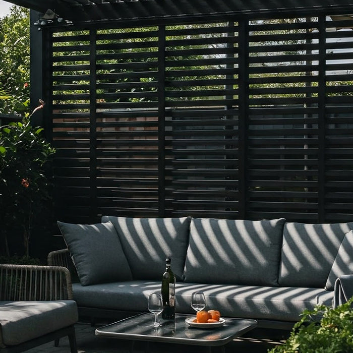 A modern pergola with slatted shade covering a patio with outdoor furniture.