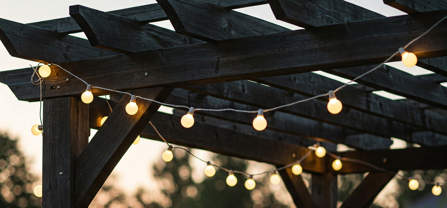 Festoon lights on wooden pergola.