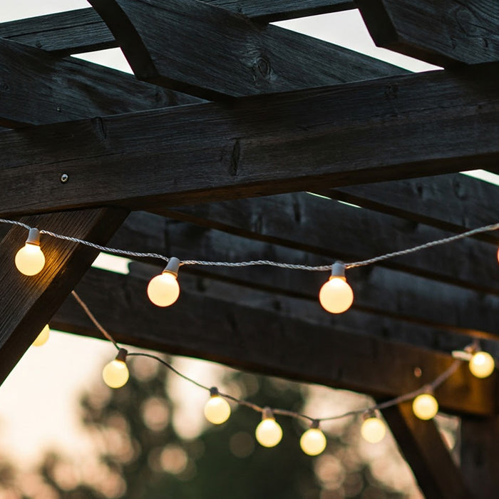 Festoon lights on wooden pergola.