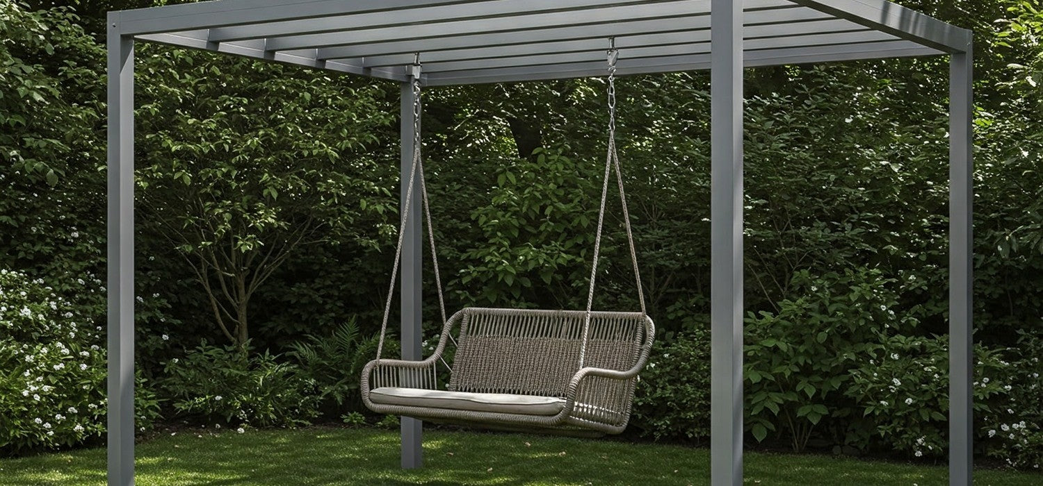 Garden swing chair hanging from an aluminium pergola