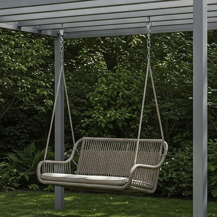 Garden swing chair hanging from an aluminium pergola