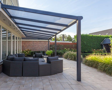 Bosco Veranda with a Polycarbonate Roof and a circular set of grey furniture underneath