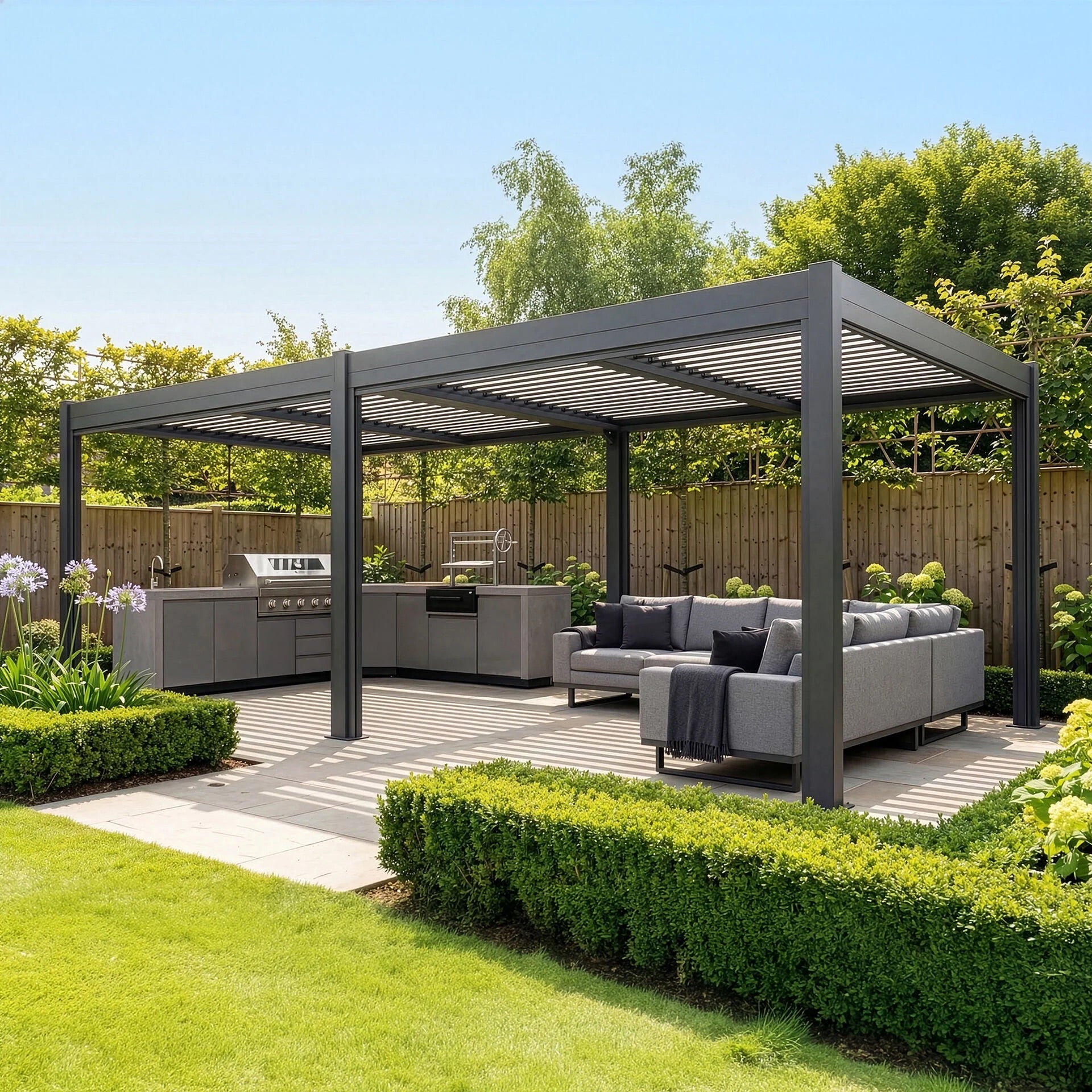Maze Como 7.8 x 3.6m Grey front angle view in summer with outdoor kitchen and lounge set