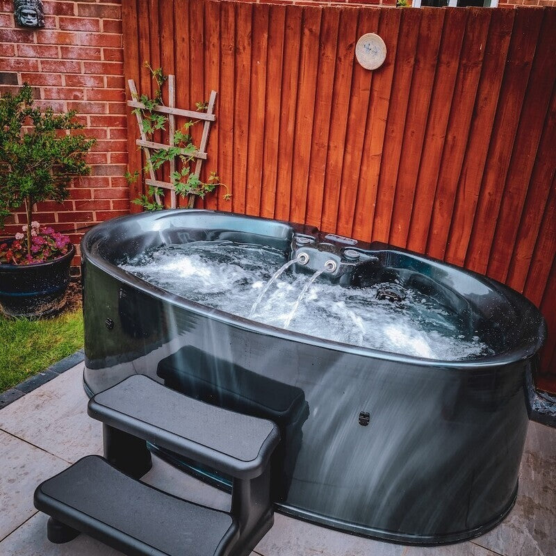 2 Person Hot tub with water flowing in a back garden setting