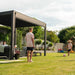 Pergola within a family garden, children are playing football