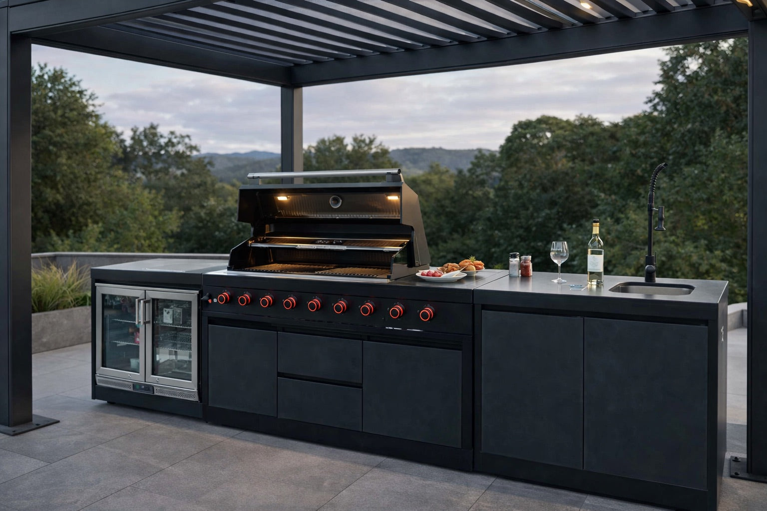 Nova Assado Plus Outdoor Kitchen under pergola on landscaped patio with a view and grill lid open