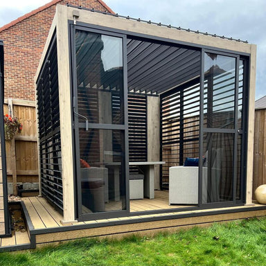 Modern garden pergola room with glass sliding doors and wooden decking