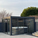 Outdoor hot tub enclosure with glass doors in a garden setting