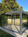Grey pergola with glass sliding doors on each side