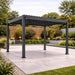 Nova Titan Aluminium Pergola in Grey - 3.6 x 3.6m lifestyle image on landscaped patio
